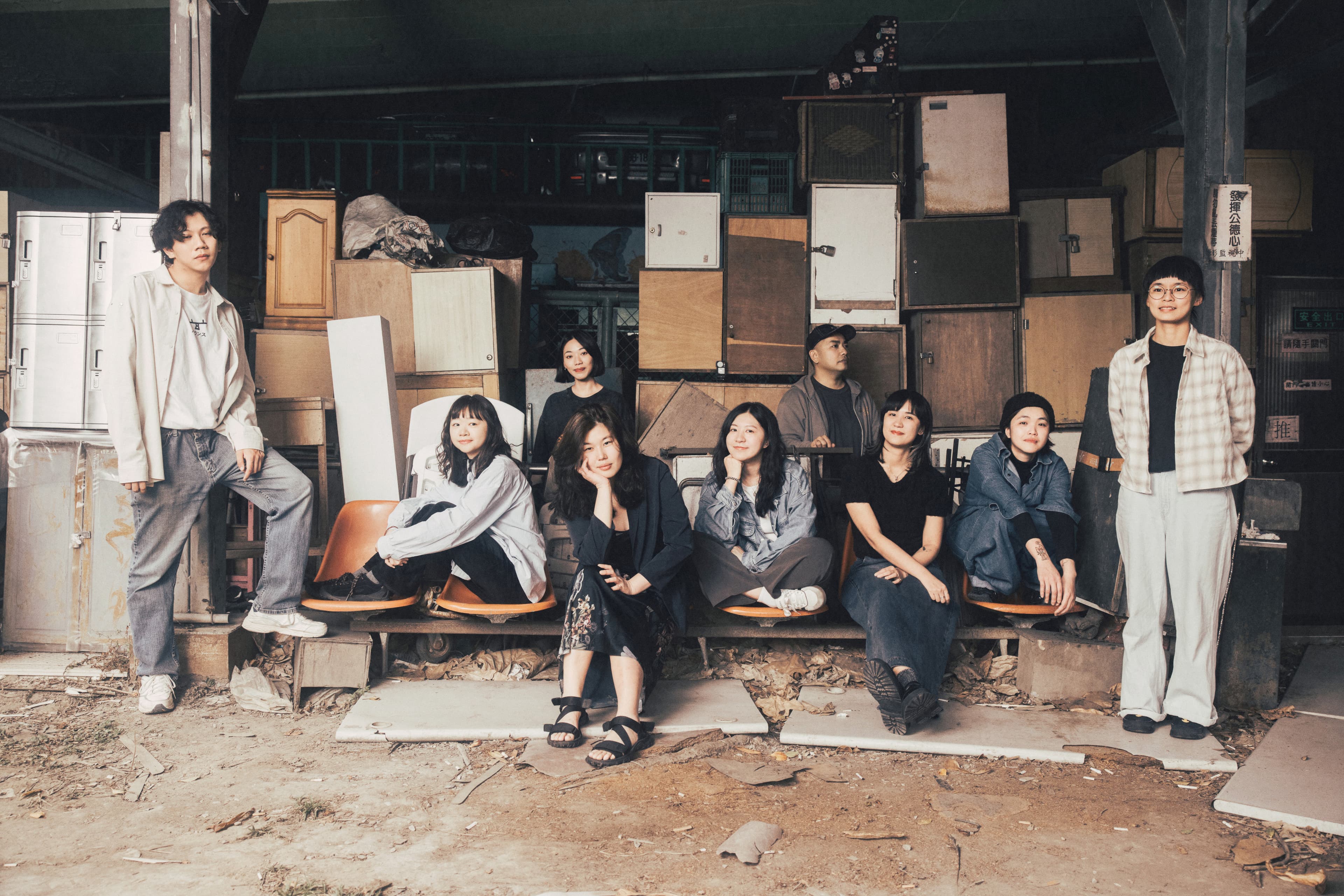The In Utero team seated among stacked lockers and cabinets