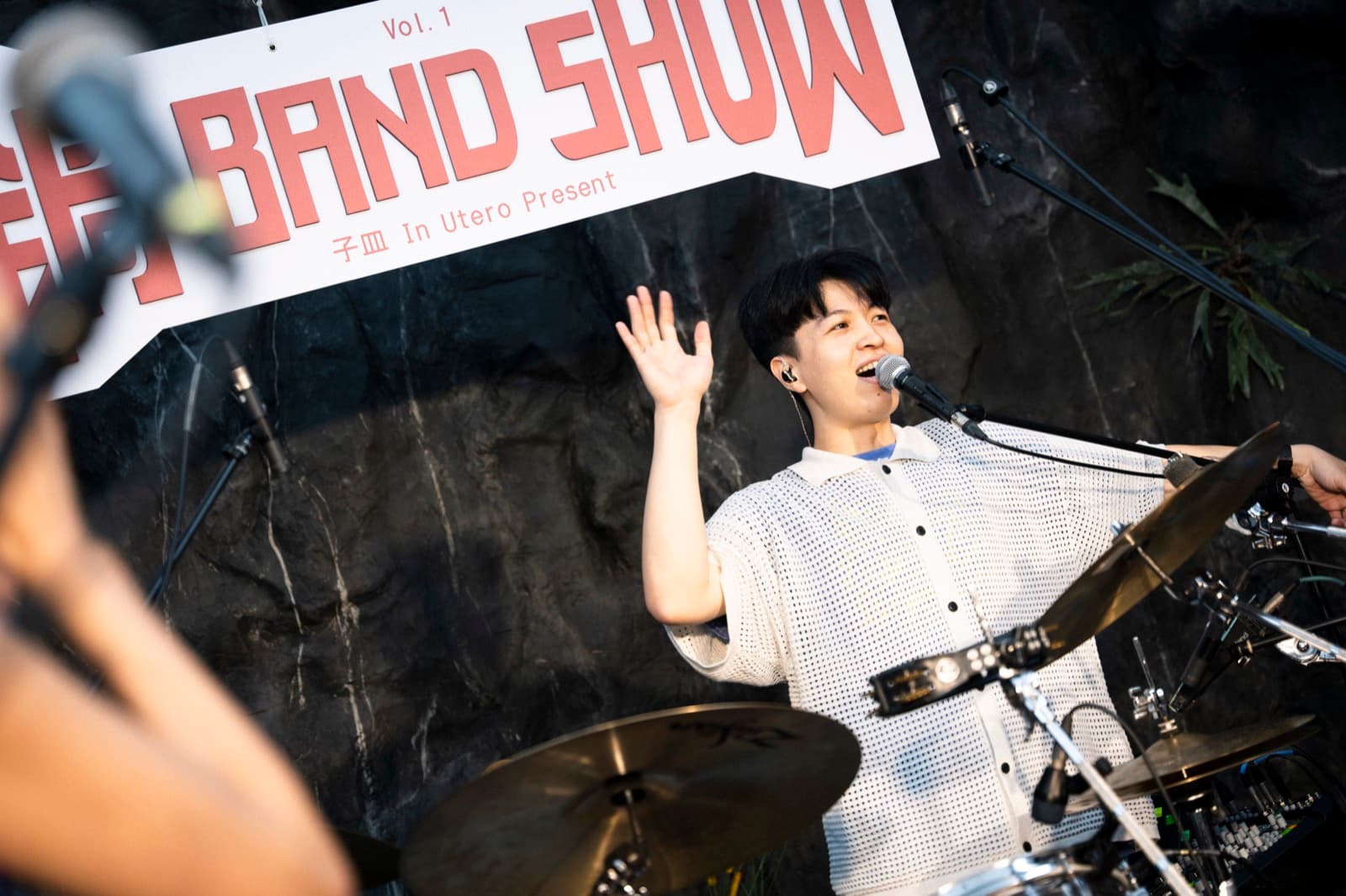 Drummer Chiachin blowing out birthday candles on stage as the crowd sings along