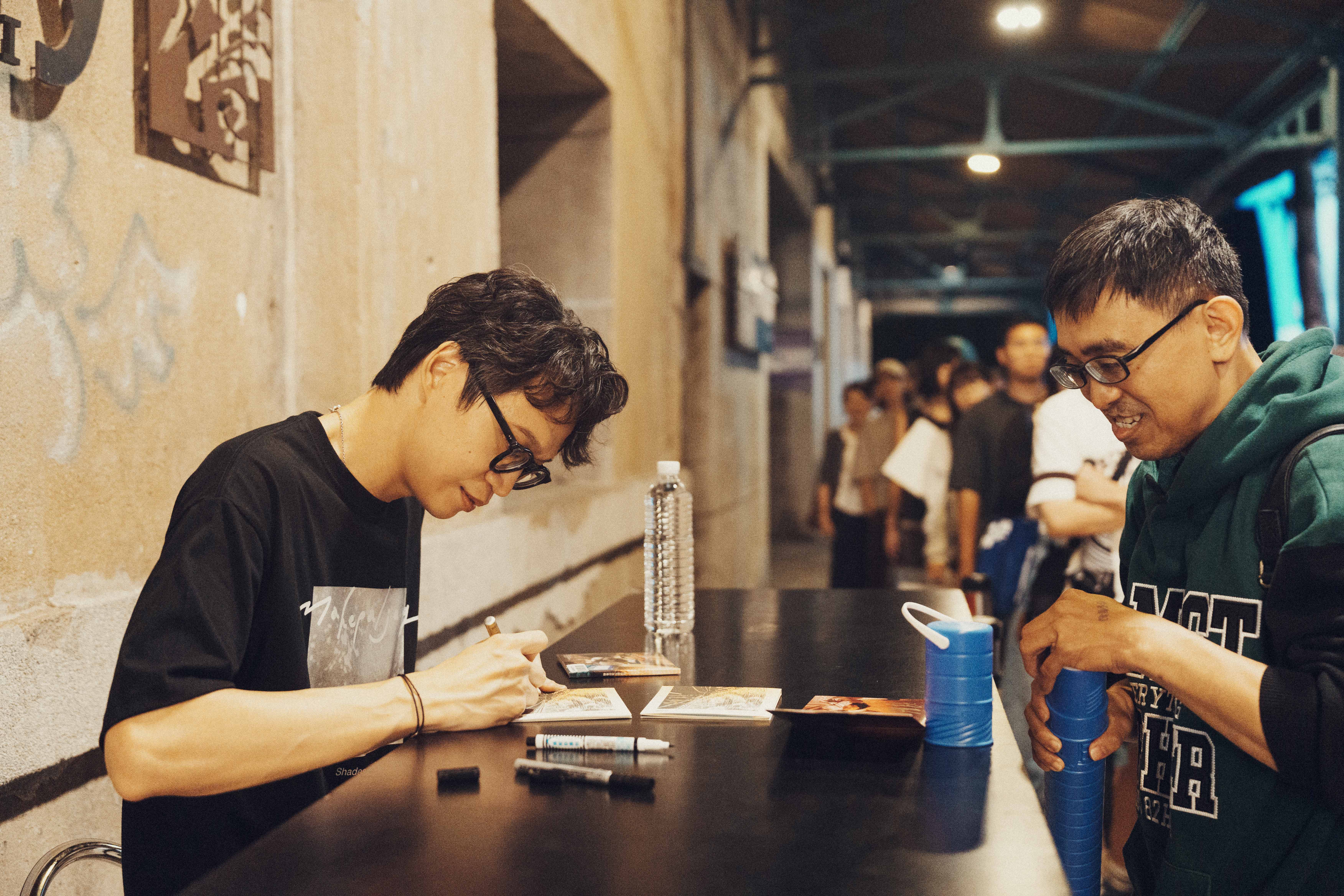 A long line of fans waited to buy merchandise and get autographs after the show