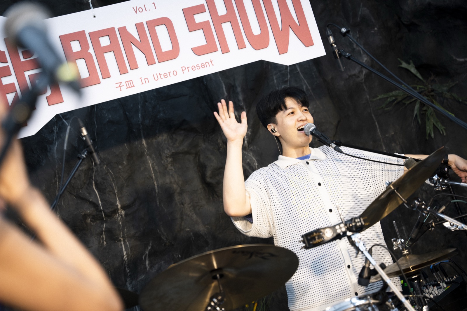 Drummer Chiachin blowing out birthday candles on stage as the crowd sings along